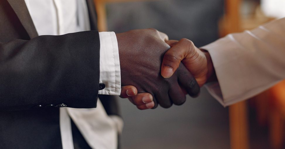 Black men in a cafe. Guy talking. Man in a black suit.